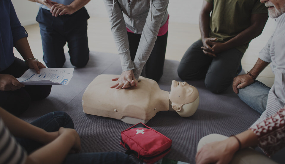 Diverse people taking a CPR first aid training class